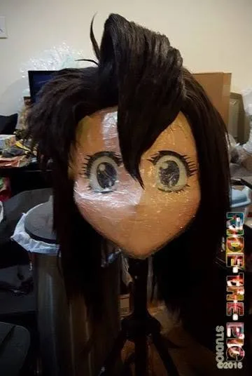 Early 2016 Ride the Pig Studio mask on a stand in a cluttered workshop