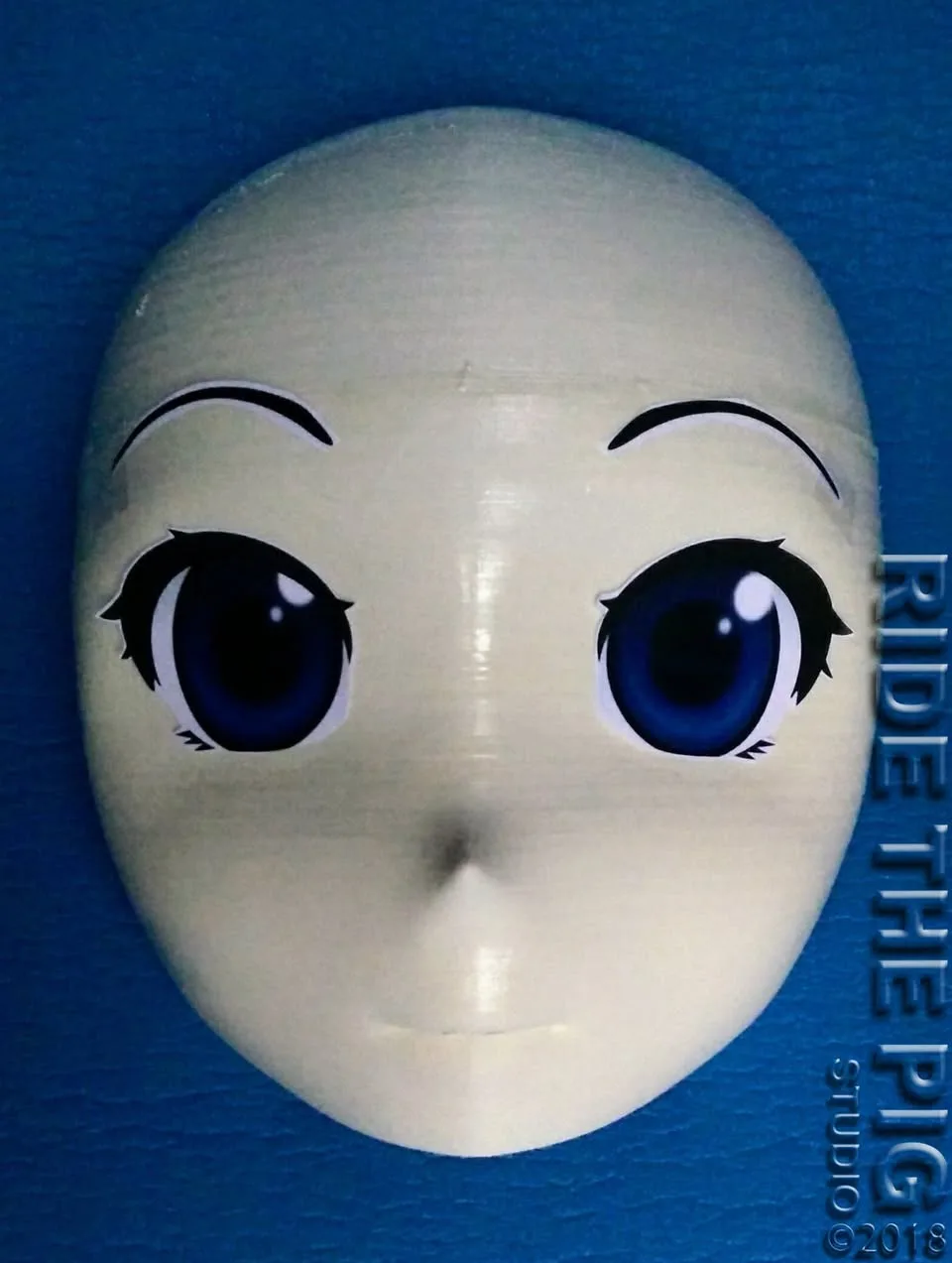 Raw 3D-printed Ride the Pig Studio mask shell with eye decals applied, 2018